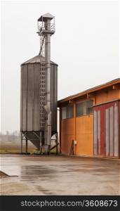 Industrial silos near a shed, vertical image