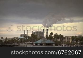 Industrial smoke from plant tube at sunset