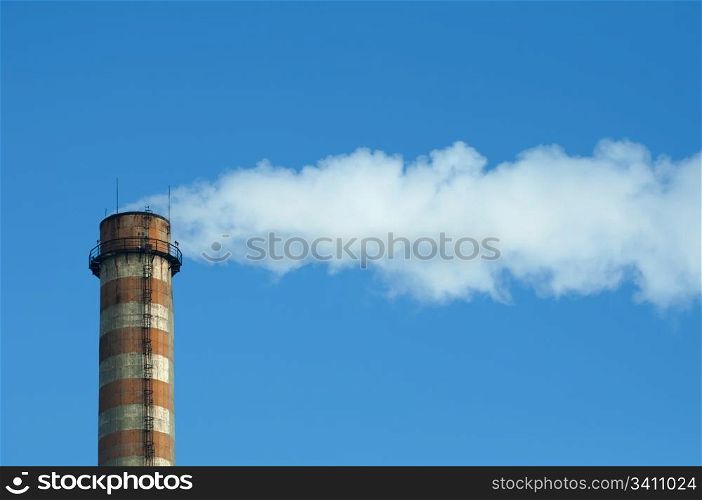 Industrial smoking chimney on blue sky. Thermal Power Plant