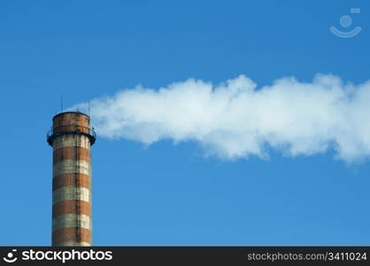 Industrial smoking chimney on blue sky. Thermal Power Plant