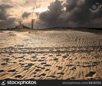 Industrial station in desert and storm clouds