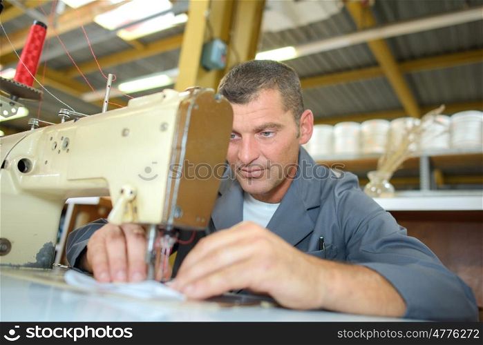 industrial tailor sewing a fabric