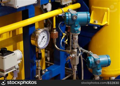 Industrial technological equipment with pipes and manometers.