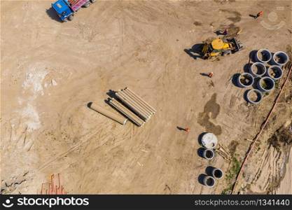 Industrial truck loader excavator moving earth and unloading. Aerial view
