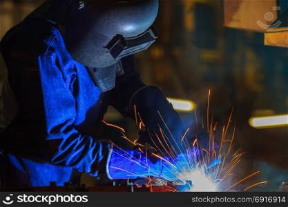 Industrial Worker at the factory welding metal ,closeup