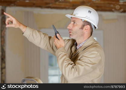 industrial worker talking on walkie-talkie