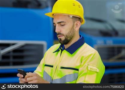 industrial worker texting on his cellphone