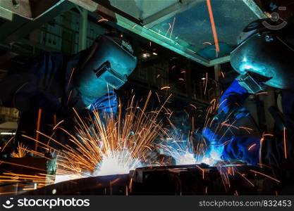 Industrial workers are repair metal part in factory