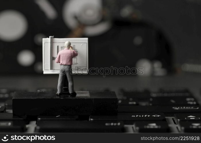 industry concept-miniature engineer working with drafting table on laptop computer