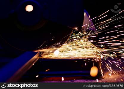 Industry electric fiber cutting steel with beautiful flash of sparks, Building construction concept. close up