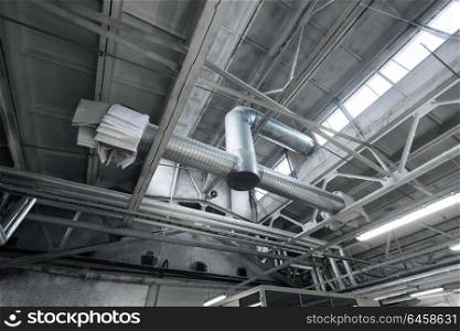 industry, manufacture and production concept - ventilation pipes system at factory shop. ventilation pipes at factory shop