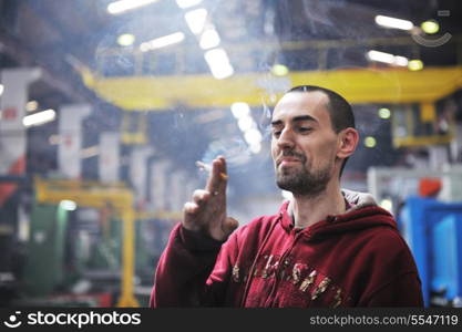 industry worker smoke cigarette at job in company at big bright hall