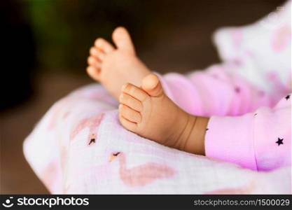 Infant baby girl legs, tiny barefoot in a selective focus, babyhood concept - Image