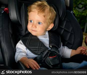 Infant boy 8 months old in a safety car seat.