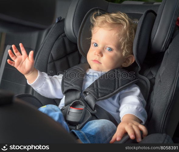Infant boy 8 months old in a safety car seat.