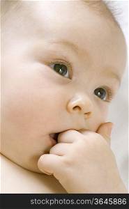 Infant child chewing on hand
