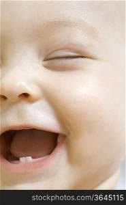 Infant child laughing with milk teeth