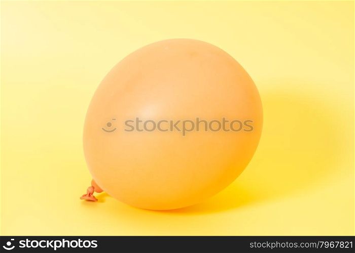 Inflatable balloon on yellow background