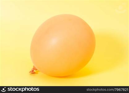 Inflatable balloon on yellow background