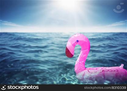 Inflatable big pink flamingo in the transparent turquoise sea. holidays background concept with copy space. trendy summer concept space for text. Inflatable big pink flamingo in the transparent turquoise sea. holidays background concept with copy space. trendy summer concept