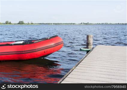inflatable red boat in the belterwiede lake in holland near giethoorn