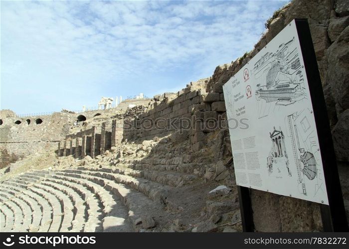 Information board and ruins of theater in acropolis of Pergam, Turkey