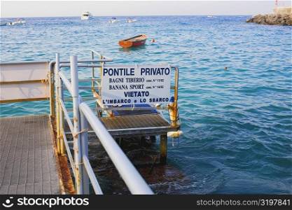 Information board on a pier, Capri, Campania, Italy
