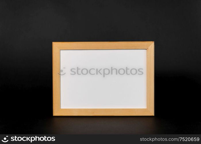 information concept - white board in wooden frame on black background. white board in wooden frame on black background