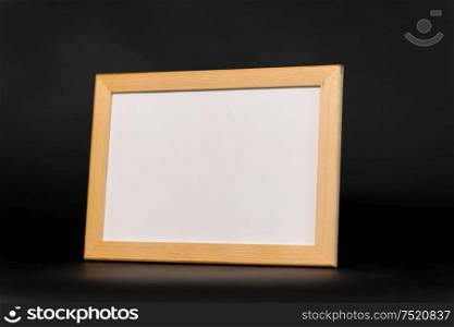information concept - white board in wooden frame on black background. white board in wooden frame on black background