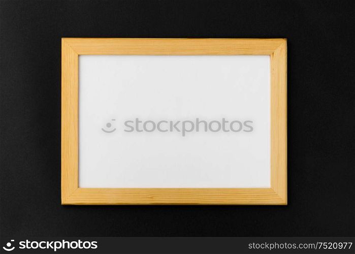 information concept - white board in wooden frame on black background. white board in wooden frame on black background
