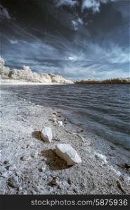 Infrared landscape of lake in English countryside in Summer with surreal colors