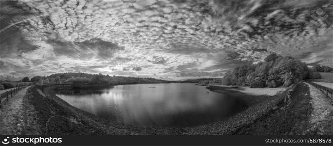 Infrared panorama landscape of lake in English countryside in Summer with surreal colors