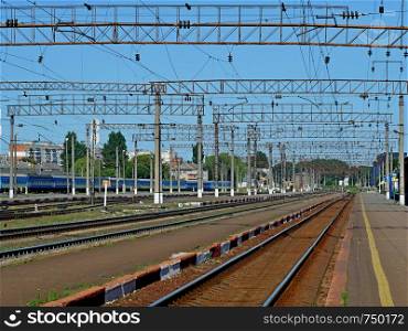 Infrastructure of railway station of Khmelnytskyi, Ukraine in sunny morning with cloudless blue sky