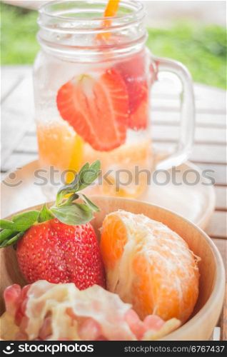 Infused water mug of mix fruit refreshing drink, stock photo