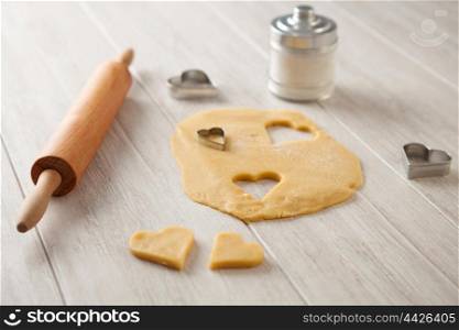 Ingredients and utensils to cook cookies on gray wood board
