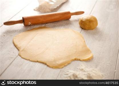 Ingredients and utensils to cook cookies on gray wood board