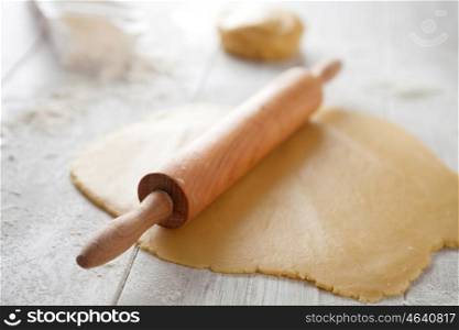 Ingredients and utensils to cook pizza on gray wood board
