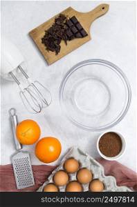 ingredients electric mixer hand grater empty bowl preparing chocolate cake white surface