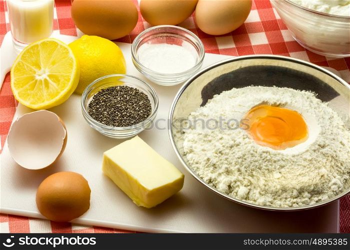 Ingredients for a cake with chia seeds - flour, butter, eggs, baking powder, sugar