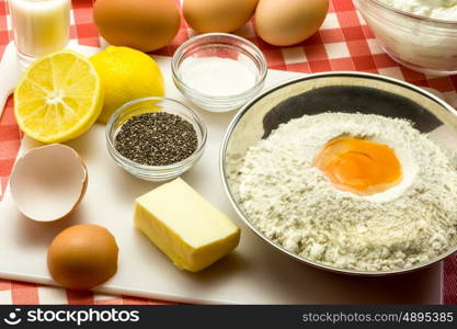 Ingredients for a cake with chia seeds - flour, butter, eggs, baking powder, sugar