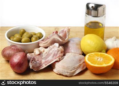 Ingredients for a Mediterranean style chicken dish with citrus fruits and green olives.