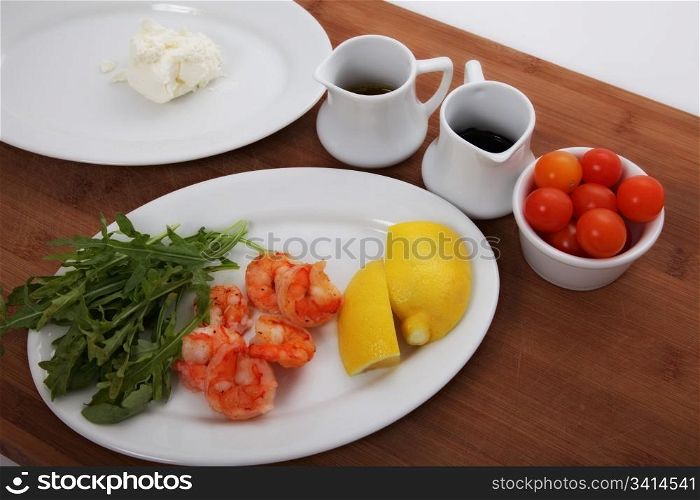 ingredients for a salad with shrimps and lemon