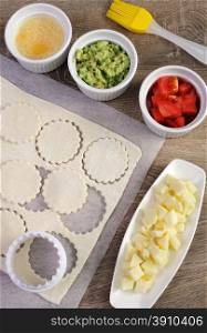 Ingredients for baking bun of puff pastry with cheese, tomato, avocado