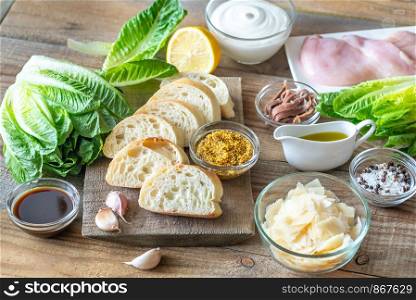 Ingredients for Caesar salad on the wooden background