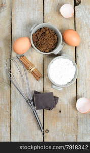 Ingredients for cake - flour, brown sugar, eggs, chocolate, cinnamon