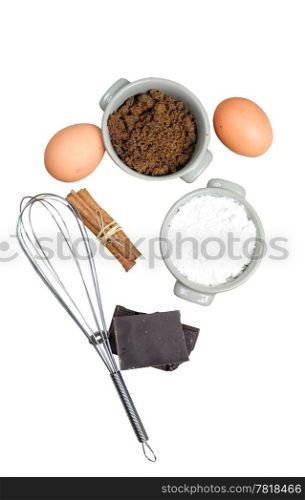 Ingredients for cake - flour, brown sugar, eggs, chocolate, cinnamon, isolated on white
