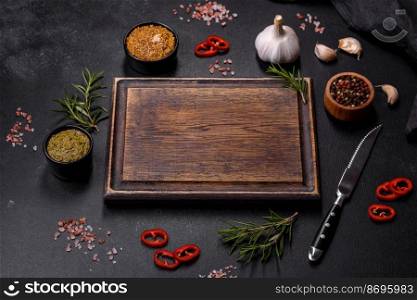 Ingredients for cooking at home  pepper, salt, rosemary, spices and herbs on a dark concrete background. Ingredients for cooking at home  pepper, salt, rosemary, spices and herbs
