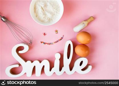 Ingredients for cooking baking - flour, egg, sugar, rolling pin on pink background. Concept of cooking dessert and sweet food. Ingredients for cooking baking - flour, egg, sugar, rolling pin on pink background. Concept of cooking dessert