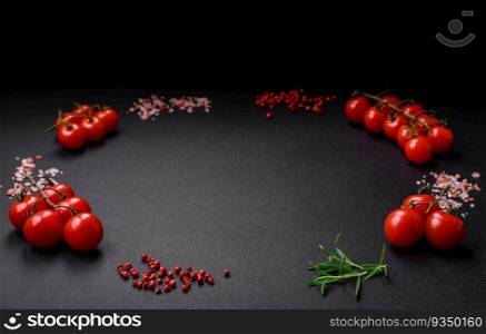 Ingredients for cooking cherry tomatoes, salt, spices and herbs on a dark concrete background. Ingredients for cooking cherry tomatoes, salt, spices and herbs