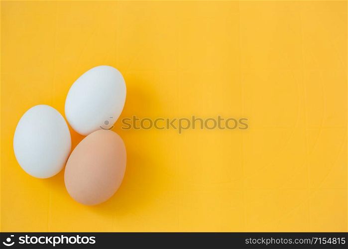 Ingredients for cooking, eggs and kitchen tools on a wooden table top view. Recipes with three eggs.. Ingredients for cooking, eggs and kitchen tools on a wooden table top view.